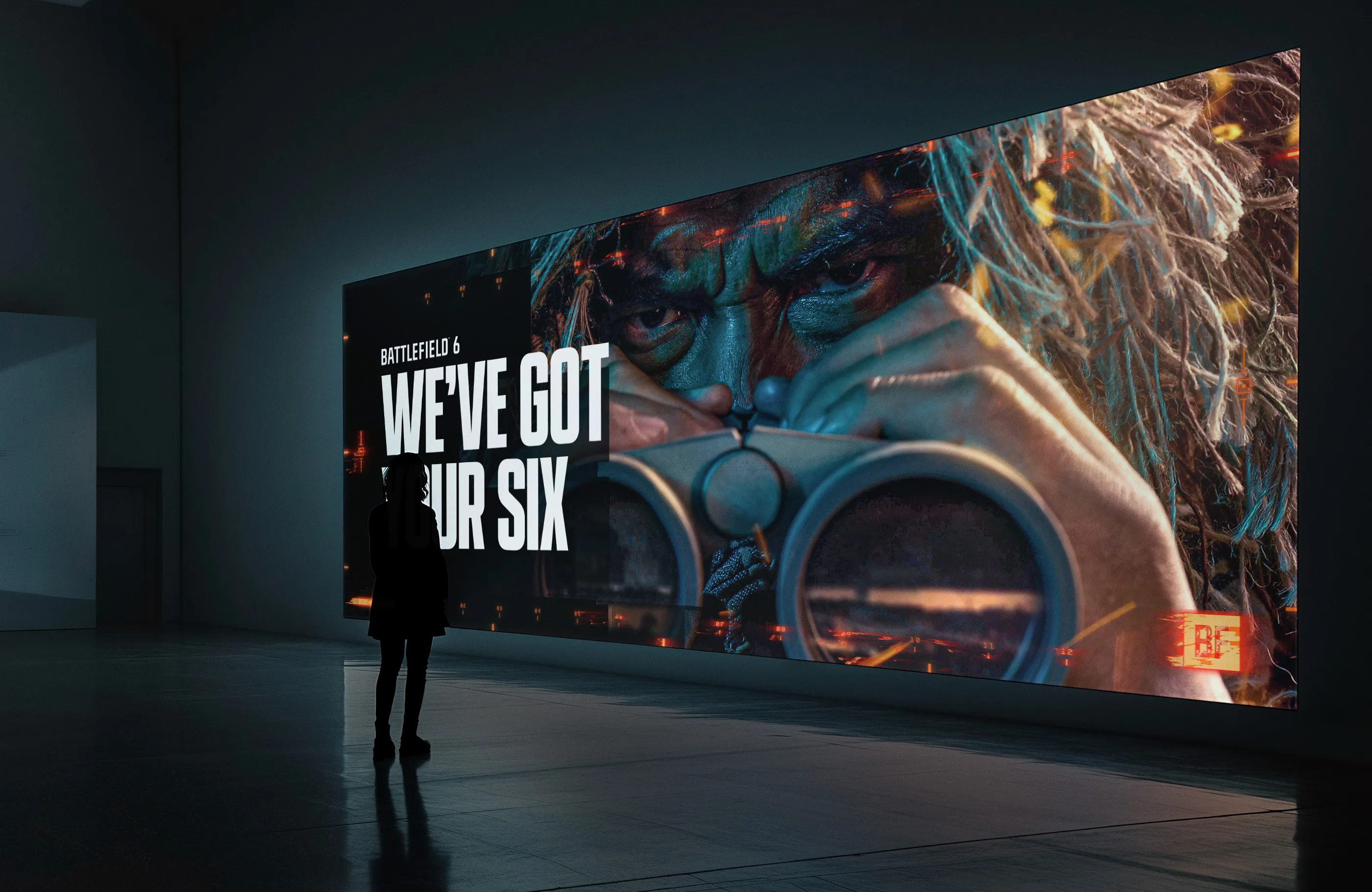 OOH advertisement featuring Battlefield 6 Recon class art in a dimly lit room.